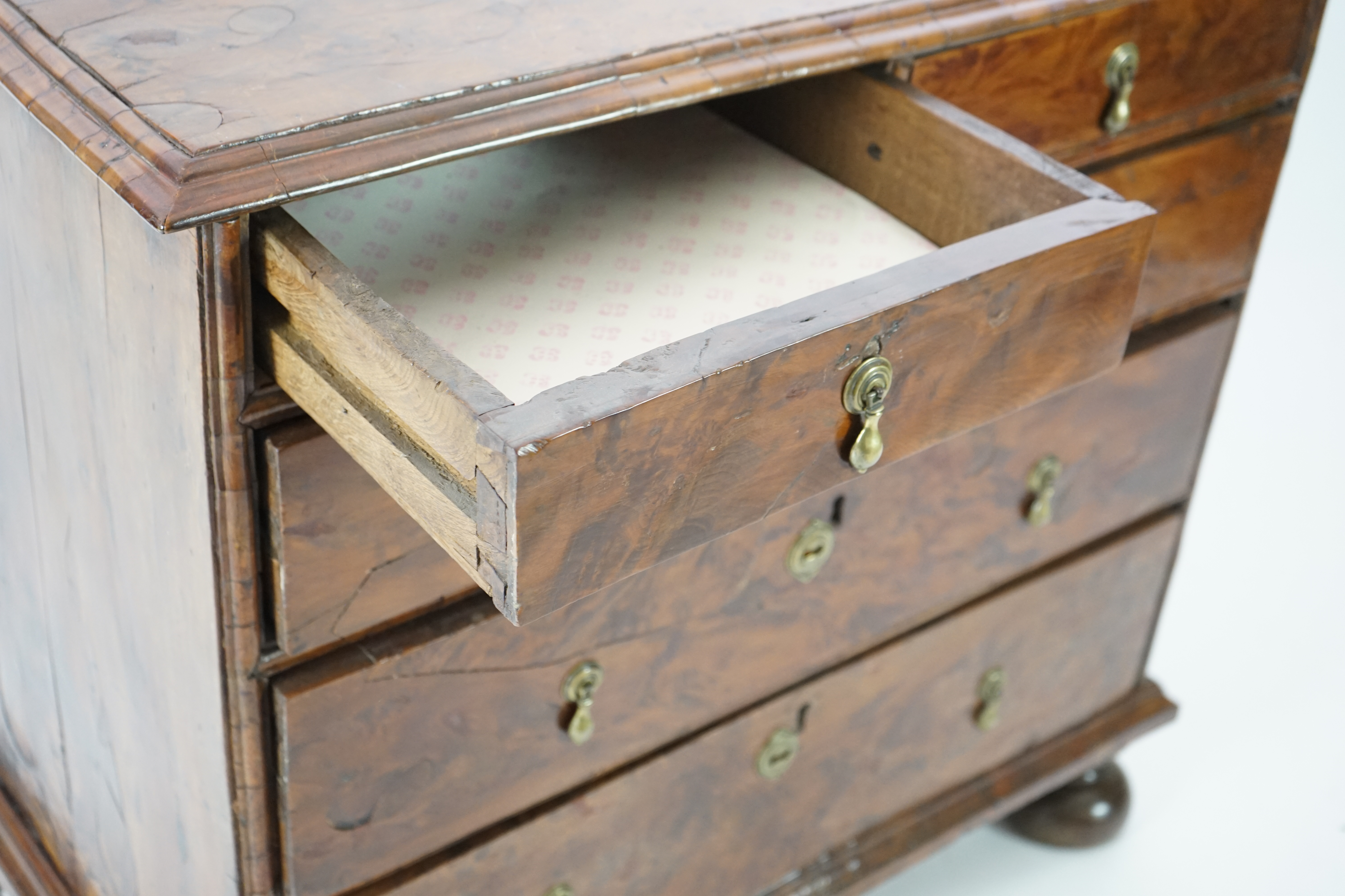 An early 18th century and later yew wood veneered oak chest